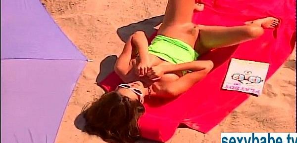  Tanned superbabe rubs herself on sandy beach